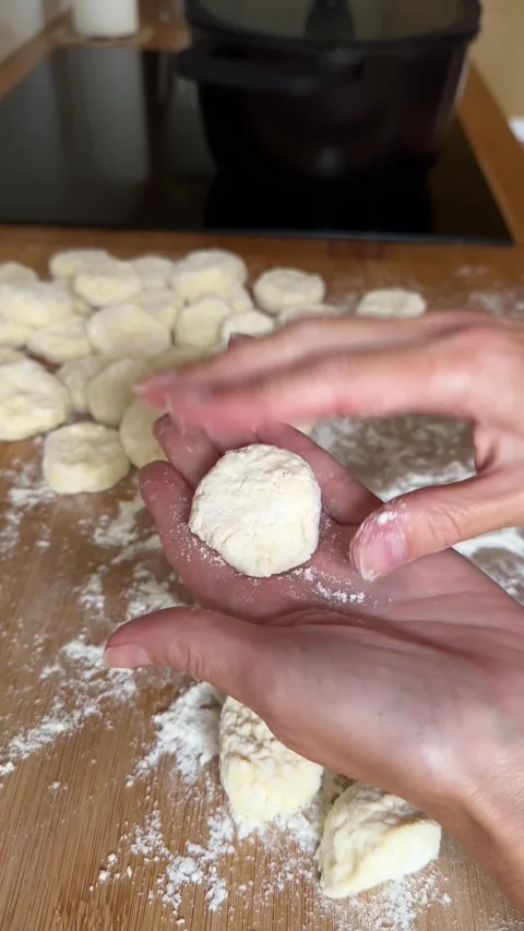 Hands Making Homemade Cottage Cheese Dumplings on Floured Wooden Table Stock Footage 344602355
