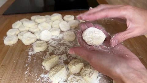 Hands Making Homemade Cottage Cheese Dumplings on Floured Wooden Table Stock Footage 344602363