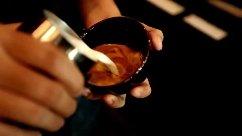 Hands making latte art coffee. Ideal morning routine concept with coffee latte. 動画素材 334648205