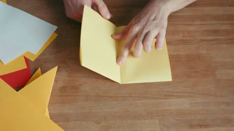 Hands making origami ship with yellow paper Stock Footage 35102073