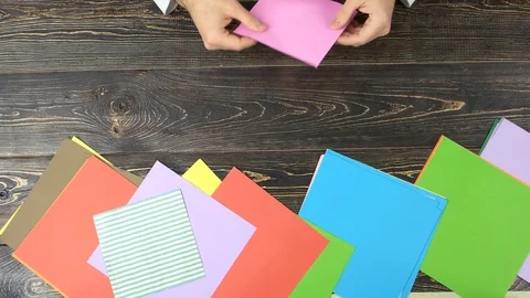 Hands making origami, top view. Video stock 89090849