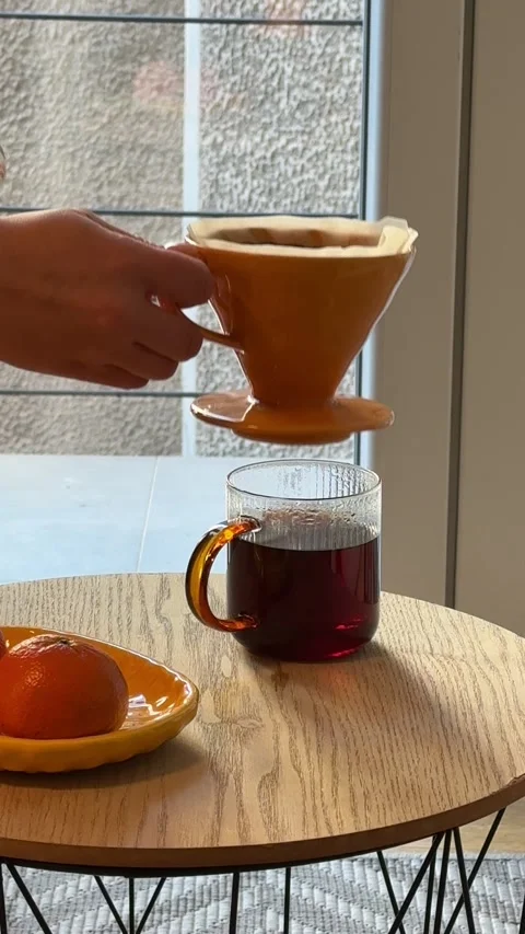 Hands making pour over coffee with ceramic dripper and paper filter Stock Footage 330860647