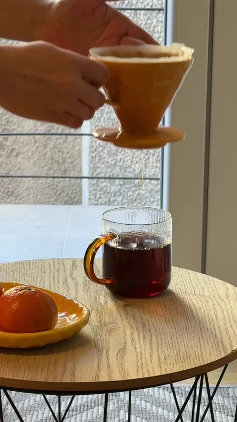Hands making pour over coffee with ceramic dripper and paper filter Видео 330860696