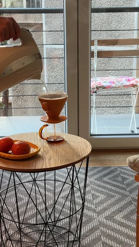 Hands making pour over coffee with ceramic dripper and paper filter Video stock 330860701