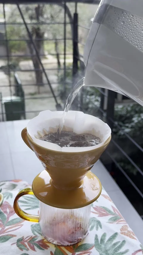 Hands making pour over coffee with ceramic dripper and paper filter Stock Footage 330861077