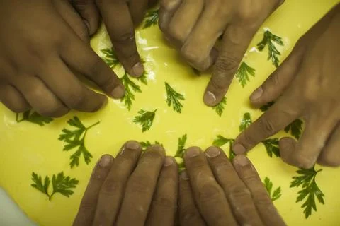 Hands making Raw and dry capeletti pasta on kitchen table Stock Photos