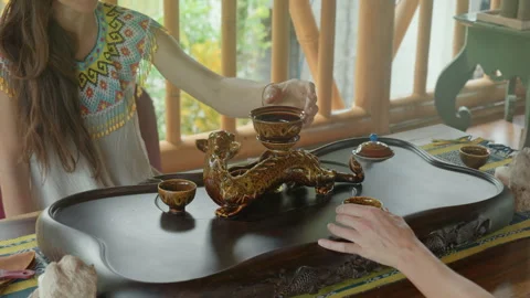The hands making a tea ceremoy on the wooden table before start of the soun.. Stock Footage 340117754