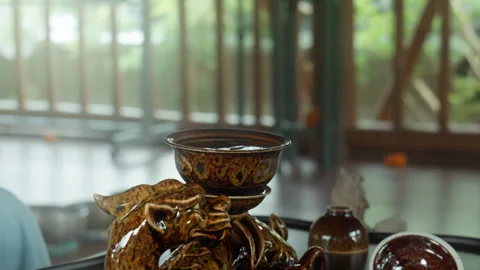 The hands making a tea ceremoy on the wooden table before start of the soun.. Stock Footage 341009882