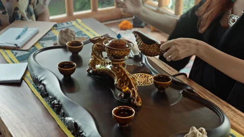 The hands making a tea ceremoy on the wooden table before the start of the .. Stock Footage 341215510