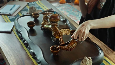 The hands making a tea ceremoy on the wooden table before the start of the .. Stock Footage 341215540