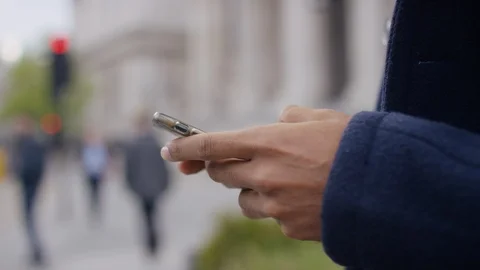 Hands of a male in the city using a cell phone Stock Footage 107873206