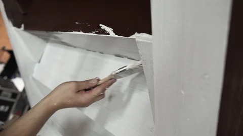 Hands of male worker actively paint grey walls in white with big brush Stock Footage 99274445