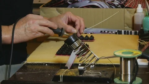 Hands of male worker while soldering electronic components at PCB by Pakito. Stock Footage 71233333