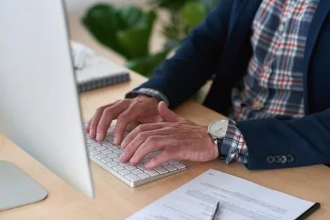 Hands, man and computer with document in office for copywriting, typing Stock Photos