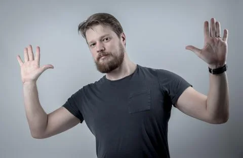 Hands up man with beard 库存照片