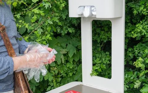 Hands of the man in cellophane gloves. Stock Photos