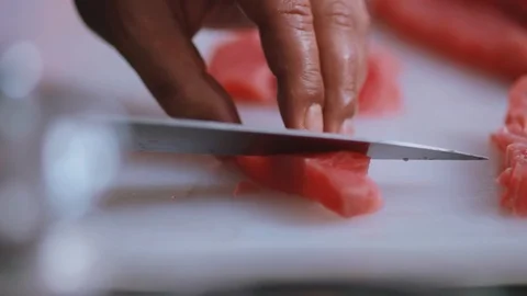 Hands man chef cuts raw meat with the knife in kitchen cooking beefsteak Stock Footage 100302974