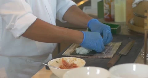 Hands of man chef preparing japanese sushi on bamboo sheet mat Stock-Footage 154931883