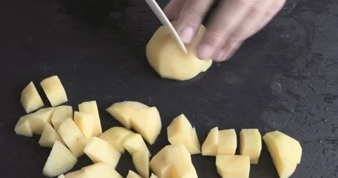 Hands of a man chop the potatoes with kitchen knife 스톡 동영상 116020403