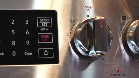 Hands of man cleaning the control panel for the oven with disinfecting wipe Stock Footage 133448768