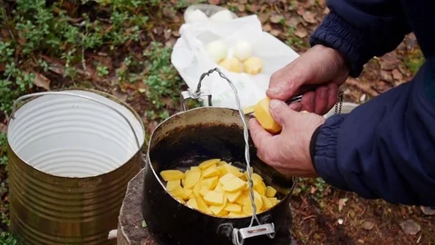 Hands of a man close up, cut potatoes in outdoor Stock Footage 70759040