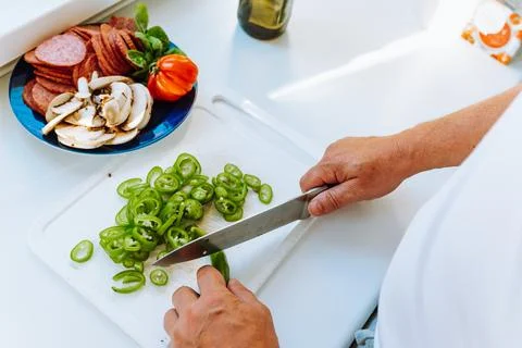 Hands man close-up top view cut pepper into slices Stock Photos