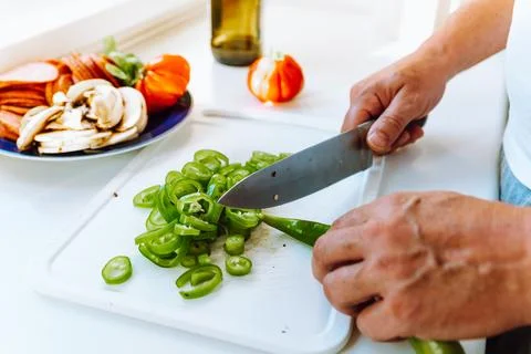 Hands man close-up top view cut pepper into slices Stock Photos