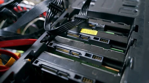 Hands of a man connect a power cable to hard drives. Stock Footage 121710074