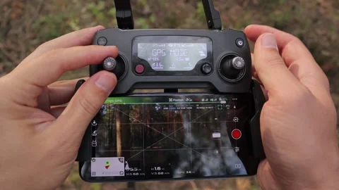 Hands of a man control the remote control from an unmanned aerial vehicle. Stock Footage 134336465
