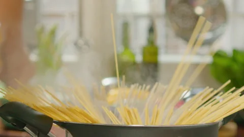 Hands of Man Cooking Spaghetti in a Pot Stock Footage 249838287
