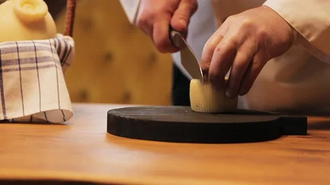 Hands of a man cut cheese on a cutting board. Stock Footage 130242178