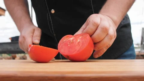 Hands of man cutting fresh tomato with knife on board Stock Footage 247434768