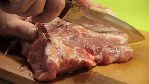Hands of a man cutting raw meat Stock Footage 84302669