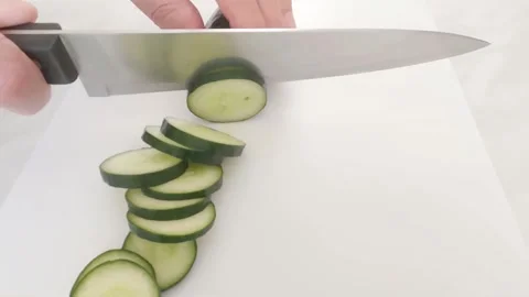 Hands of a man cutting slices of cucumber Stock Footage 280415538