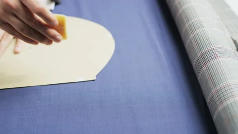 Hands of a Man Drawing an Oval Shape on a Blue Material Stock Footage 89665466