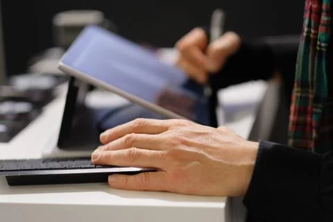 The hands of a man engaged in work with information. Stock Photos