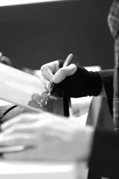 The hands of a man engaged in work with information. Stock Photos