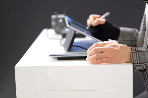 The hands of a man engaged in work with information. Stock Photos