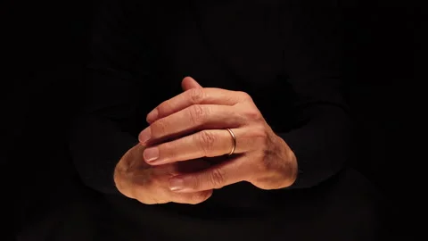 Hands of man in foreground slipping ring on finger. Concept of Loyalty Stock Footage 224926917