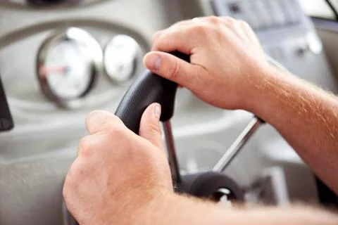 Hands of a man on the helm of a ship on the background of a dashboard boat Stock Photos