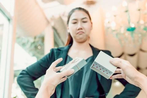 Hands man hold empty gift box and women with face angry. Stock Photos