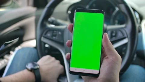 The hands of a man holding his smartphone (green screen surface, easy to Stock Footage 220762755