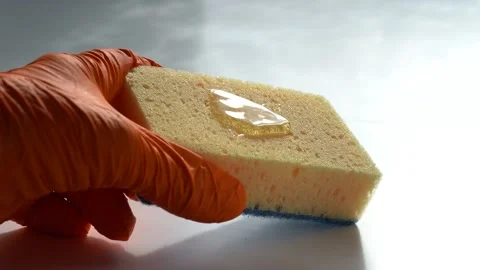 Hands of Man Holding a Kitchen Sponge with few Drops of dish Wash Gel. Household Stock Footage 152243398