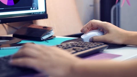 Hands of man holding a mouse and printing on a keyboard. Work at the computer Stock Footage 118959294
