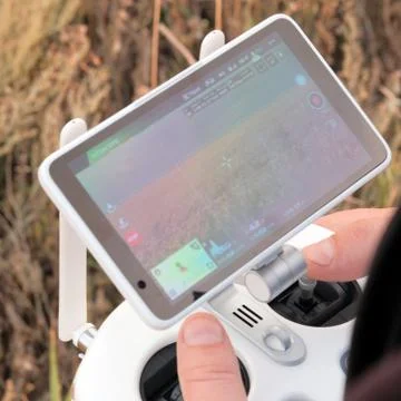 Hands of a man on the joystick control panel of an unmanned aerial vehicle. T Stock Photos