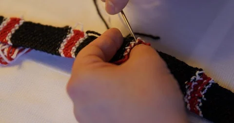 Hands of a man knitting a tie. wool thread being sewed with needle. Stock Footage 120041464