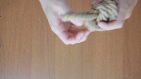 Hands of a man knotting a knot on a rope Stock Footage 74312799