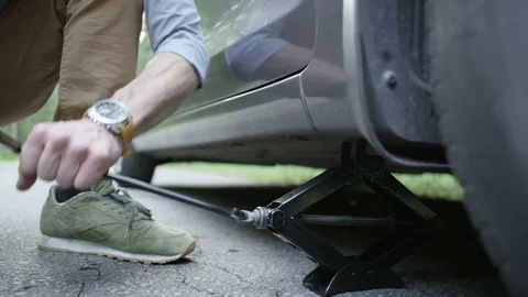Hands of a Man Lifting the Car Off the Ground With the Jack 스톡 동영상 79888333
