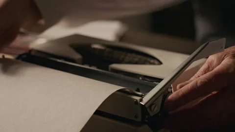 Hands of Man Loading Paper into Vintage Typewriter Stock Footage 312140524