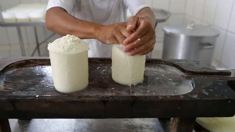 Hands of man making fresh cheese in factory of farm. Stock Footage 128375109